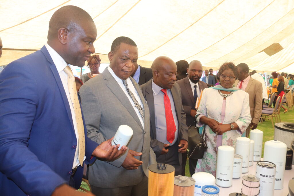 Vice President Chiwenga, second from left being shown car filters by Dr KudaMutenda in blue suit.